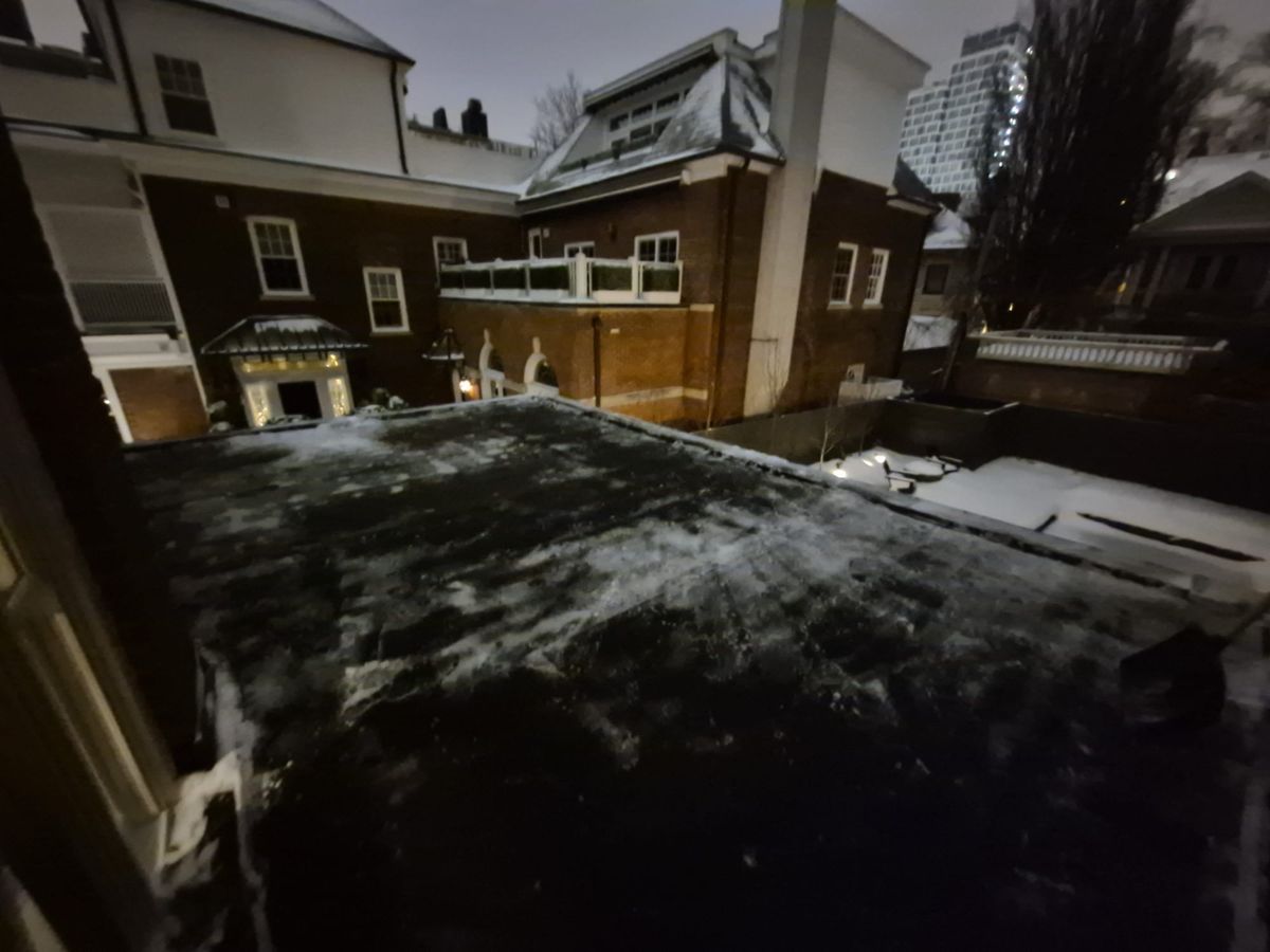 Night view of a flat roof with the heavy snow shovelled off