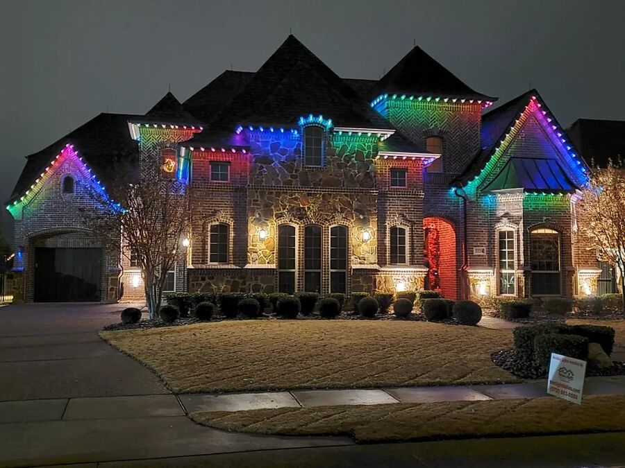 Roofline of a home glowing with multicolour LED track lights